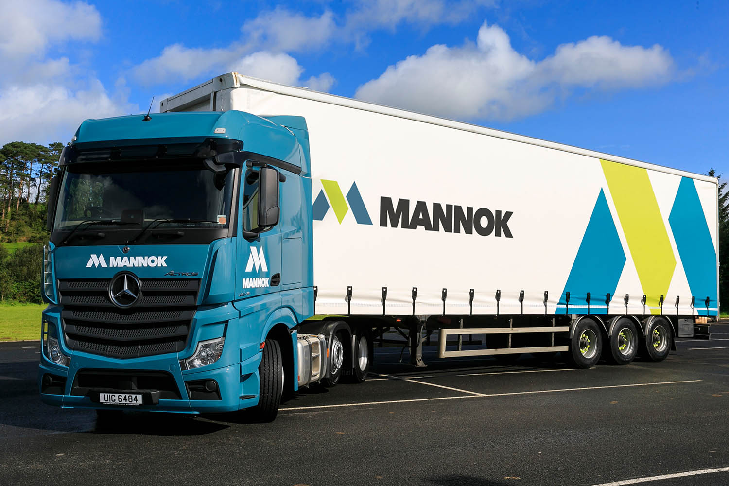 A photocall image of Mannok Operations Manager Kevin Lunney, CEO Liam McCaffrey, and CFO Dara O'Reilly in front of a Mannok branded truck